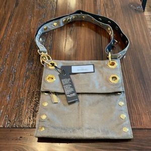 Hammitt cross body bag with brass accents.